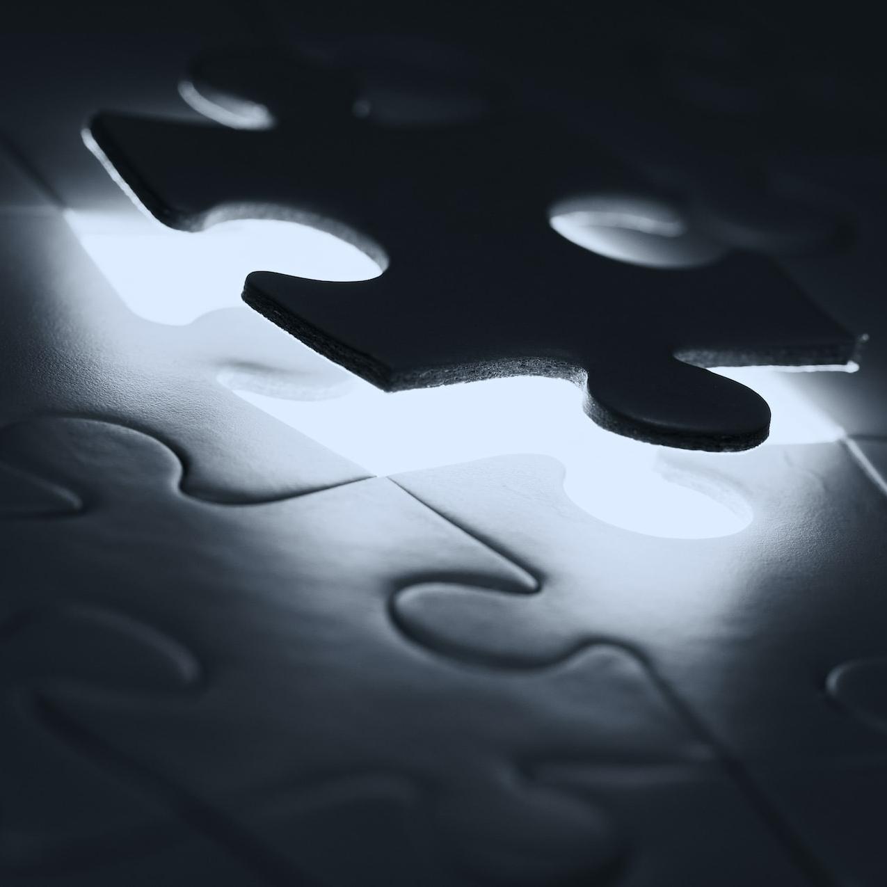 black puzzle piece on white paper